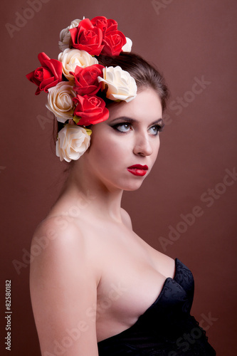 Girl with flowers in head over brown background