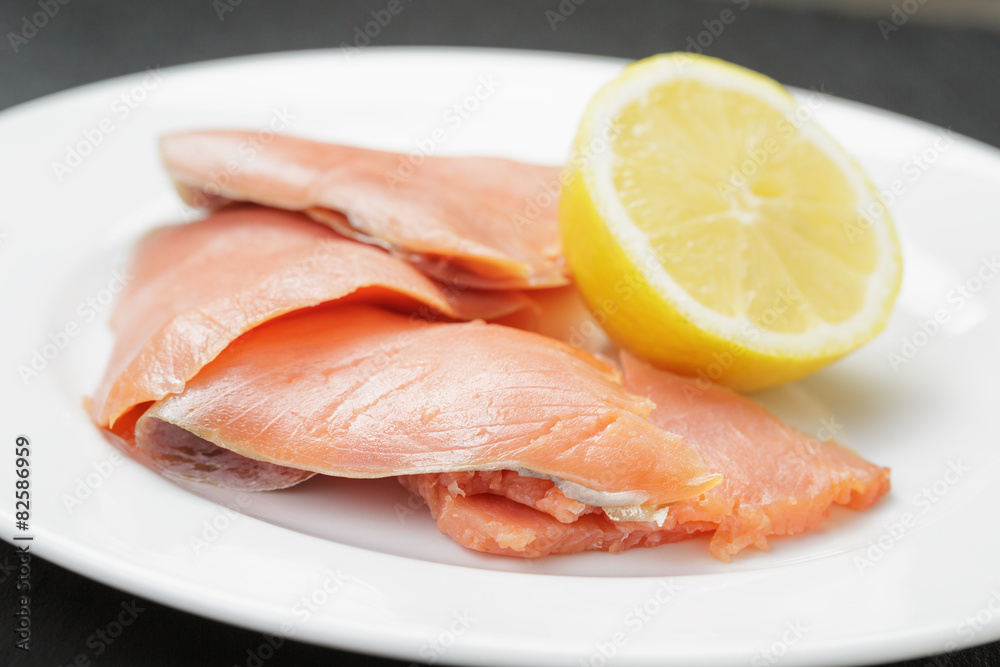 rolls of sliced smoked salmon on slate board rolls of sliced smoked salmon on slate board