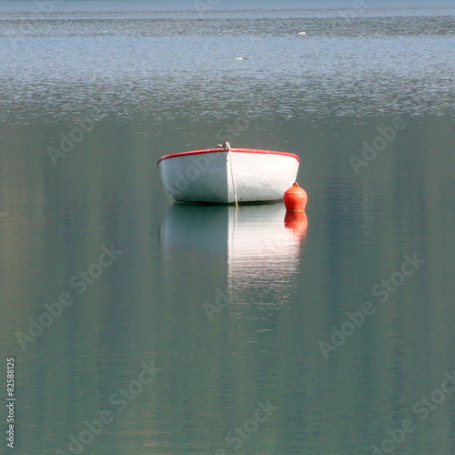 Single empty boat and its reflection 