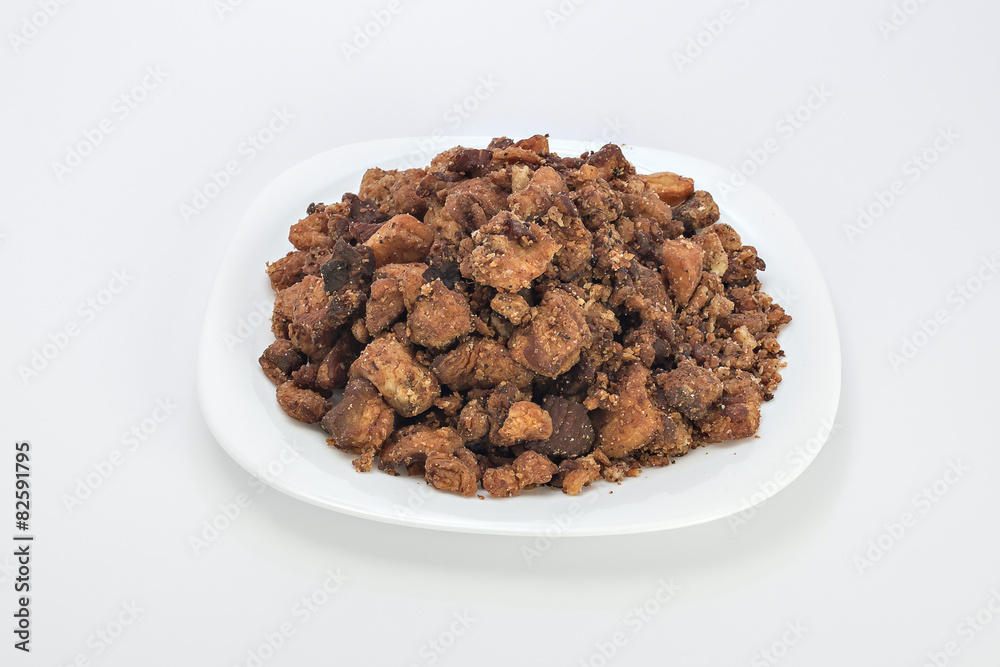 Cvarci, pork greaves on plate isolated on white Cvarci, pork greaves on plate isolated on white
