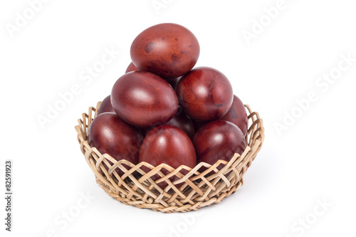 Onion shell easter eggs in basket on white background