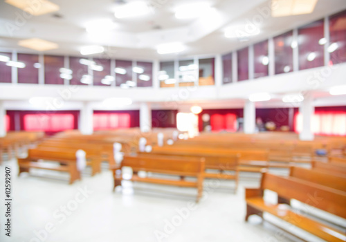 Blurred interior of empty church with empty pews