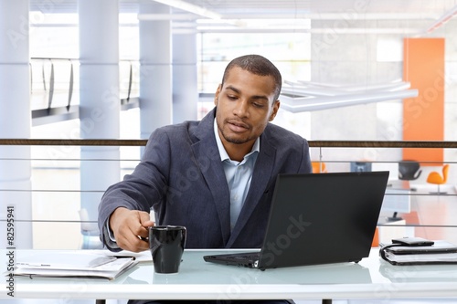 Black businessman working with computer in office