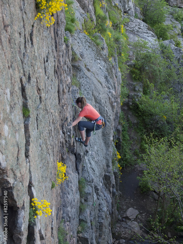 A young girl engaged in rock climbing.
