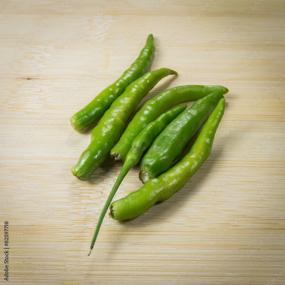 Green peppers on wooden table Green peppers on wooden table