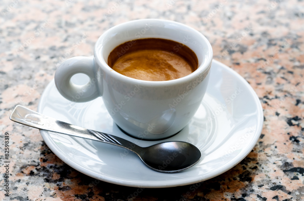 White espresso cup standing on the marble table White espresso cup standing on the marble table