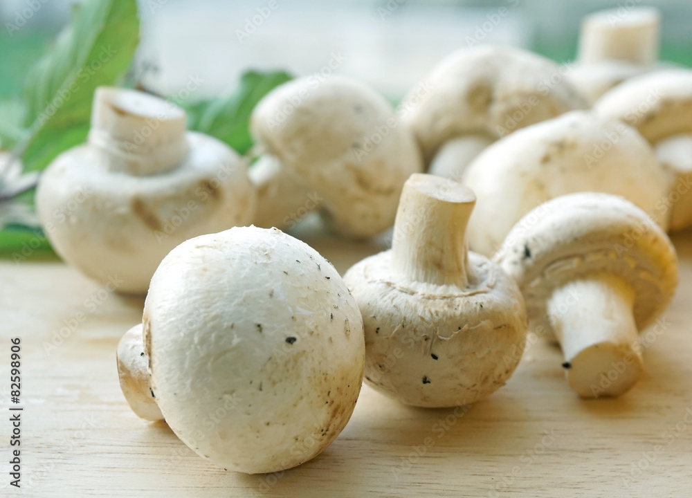 champignon mushrooms on a old wooden background champignon mushrooms on a old wooden background