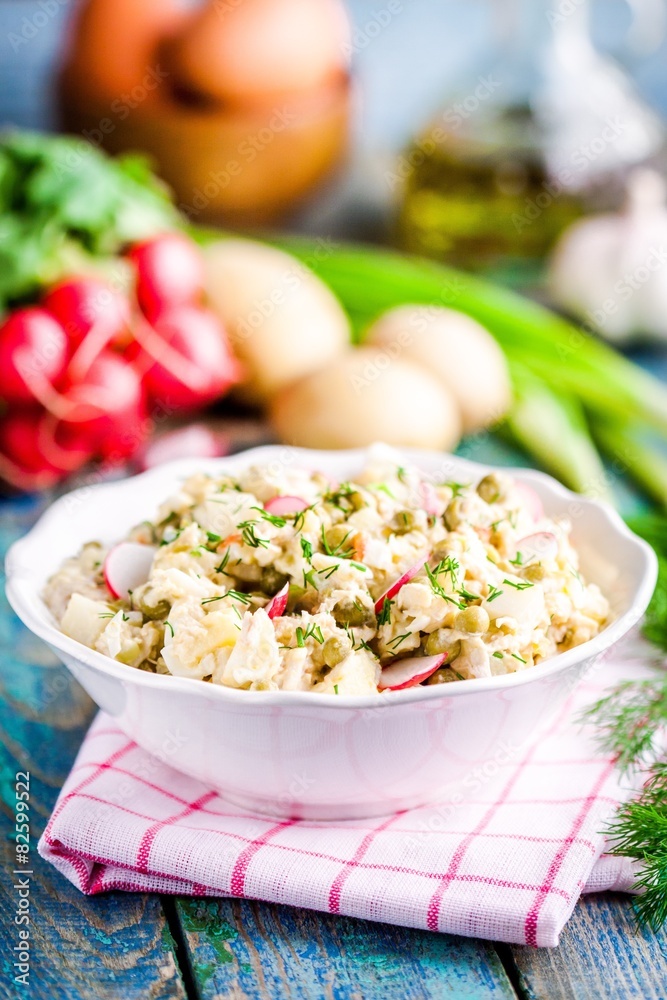 potato salad with fresh radishes and dill in a white bowl potato salad with fresh radishes and dill in a white bowl