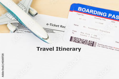 Travel itinerary with copy space, plane model, and boarding pass