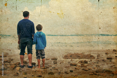 father and son walking on the beach