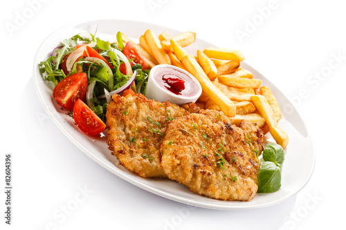 Fried pork chops, French fries and vegetables