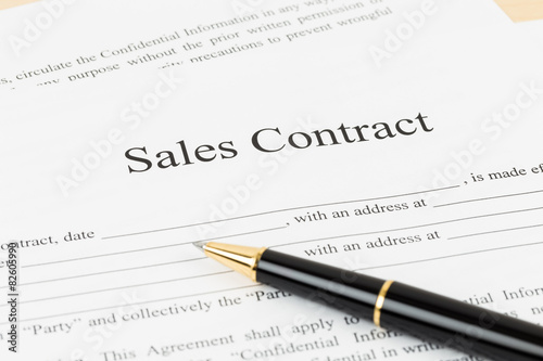 Sales contract document with pen, document is mock-up © wirojsid