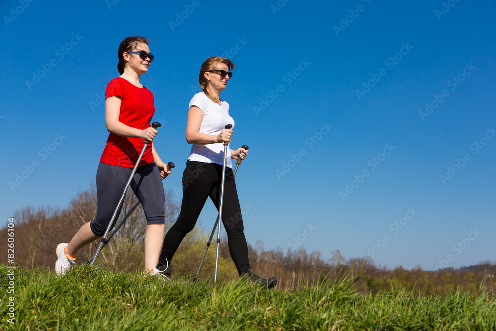Nordic walking - active people working out outdoor Nordic walking - active people working out outdoor
