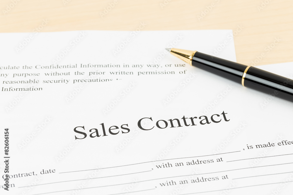 Sales contract document with pen, document is mock-up Sales contract document with pen, document is mock-up