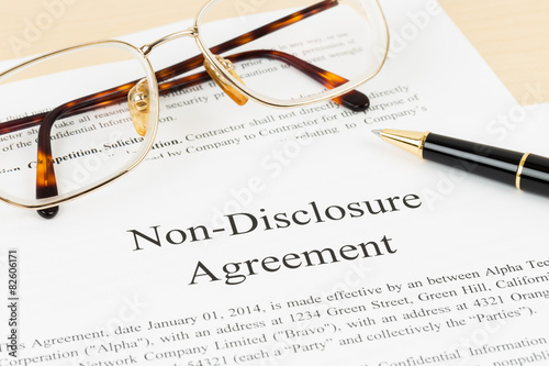 Non disclosure agreement document with pen and glasses; document