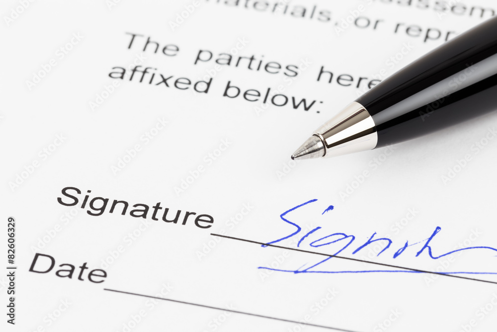 Signature on document with pen, signature is mock-up Signature on document with pen, signature is mock-up
