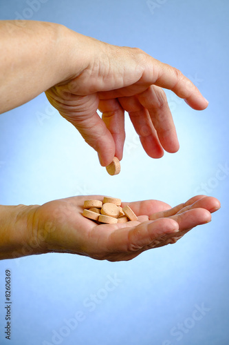 Closeup of senior woman's hand holding medications
