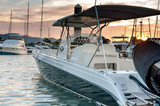 Small motorboat docking at the marina at sunset time