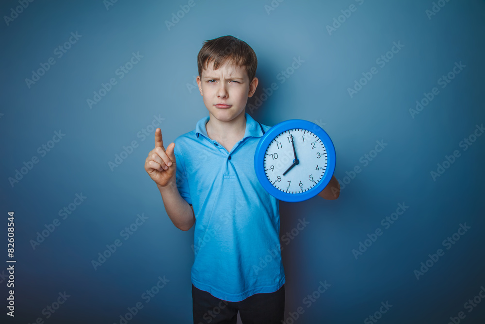 teenager boy Brown European appearance in a blue shirt holding a teenager boy Brown European appearance in a blue shirt holding a