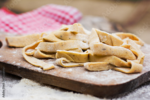 Homemade spaghetti, pasta or noodles on wooden table. 