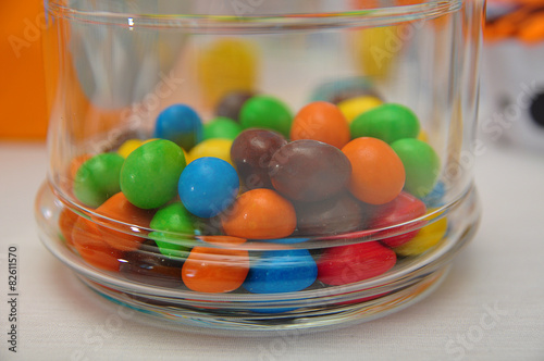 Sweet colorful candy in clear glass decanter