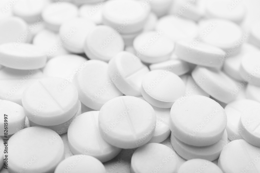 Pile of white pills, closeup Pile of white pills, closeup