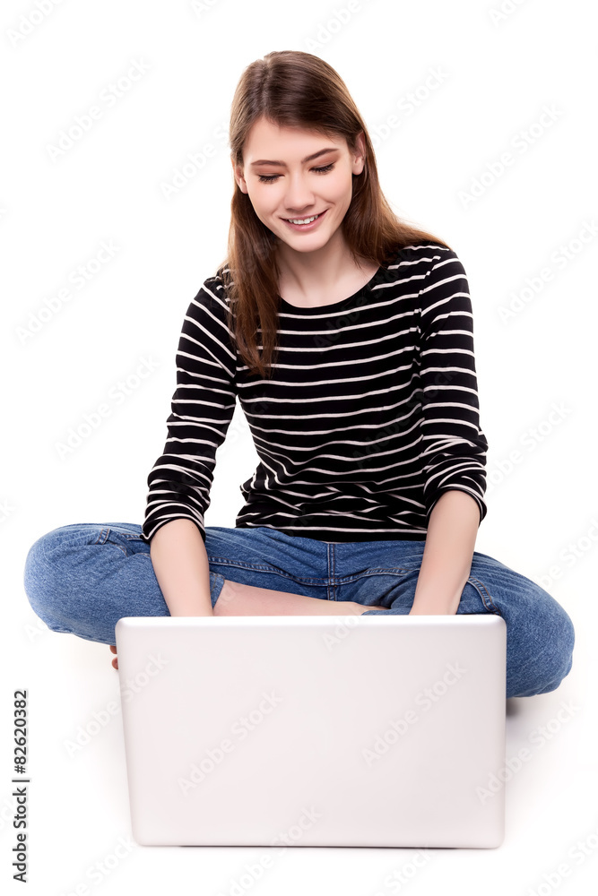 Naklejka premium Young Happy Woman with PC on Floor E-commerce Stock Image