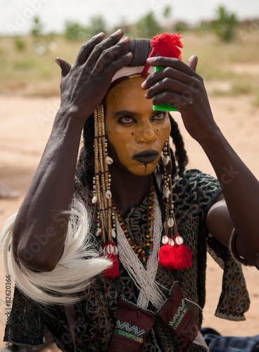 Wodaabe man checking makeup in a mirror, Gerewol, Niger