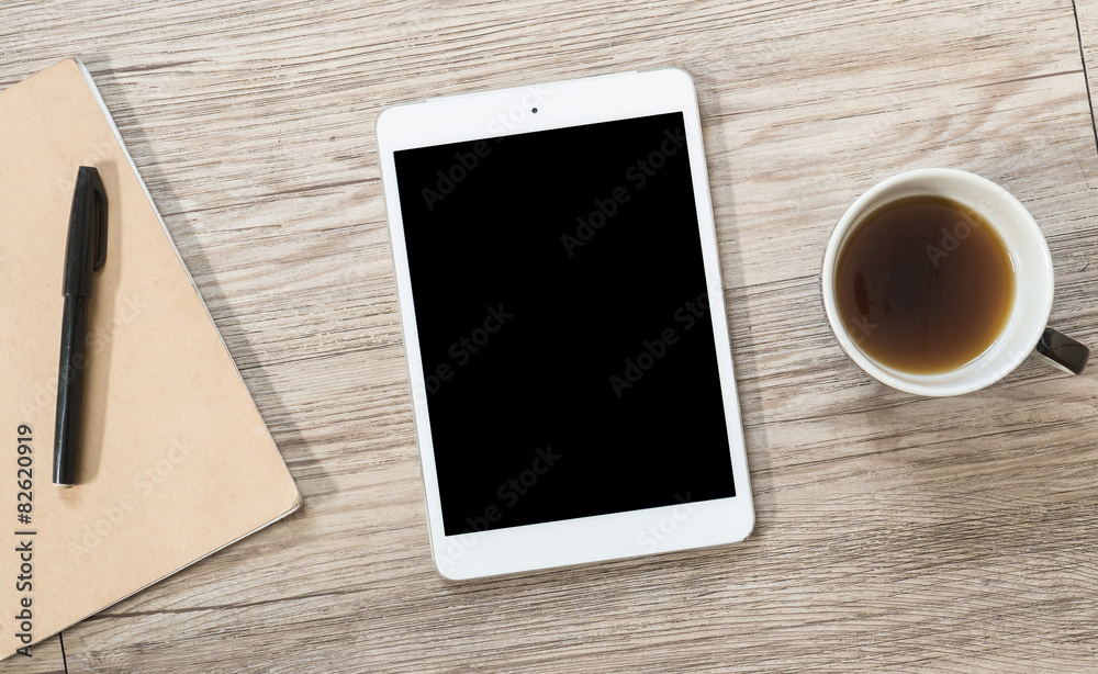 White Tablet with blank black screen on the wooden background White Tablet with blank black screen on the wooden background