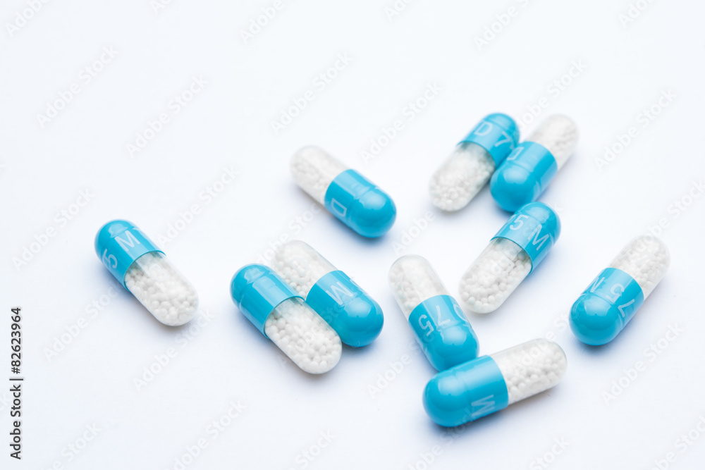 Blue pill capsules isolated over white background
