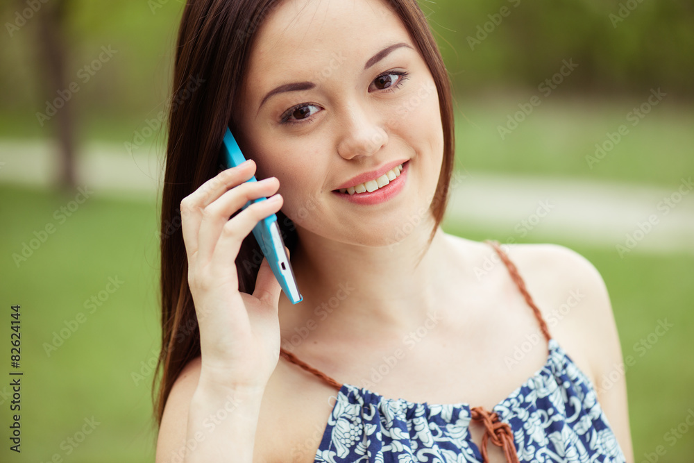 Young beautiful smiling woman talking on cell phone Young beautiful smiling woman talking on cell phone
