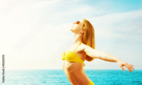 young happy woman on the beach in a bikini © JenkoAtaman