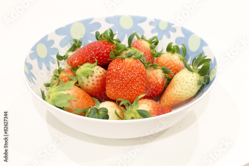 Fresh strawberry in bowl isolated on white background
