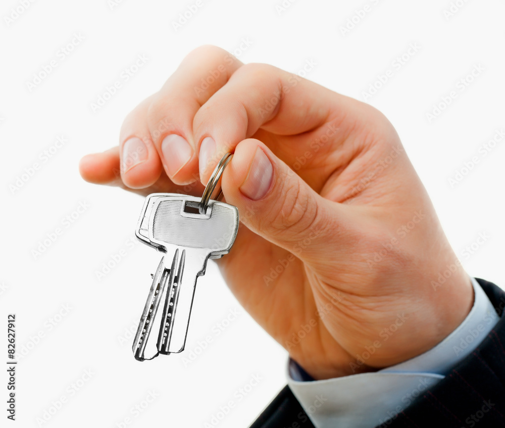 House keys in the female hand on a white background House keys in the female hand on a white background