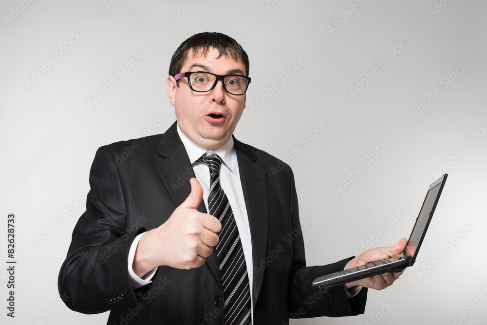 businessman holding a laptop, thumb to the top businessman holding a laptop, thumb to the top