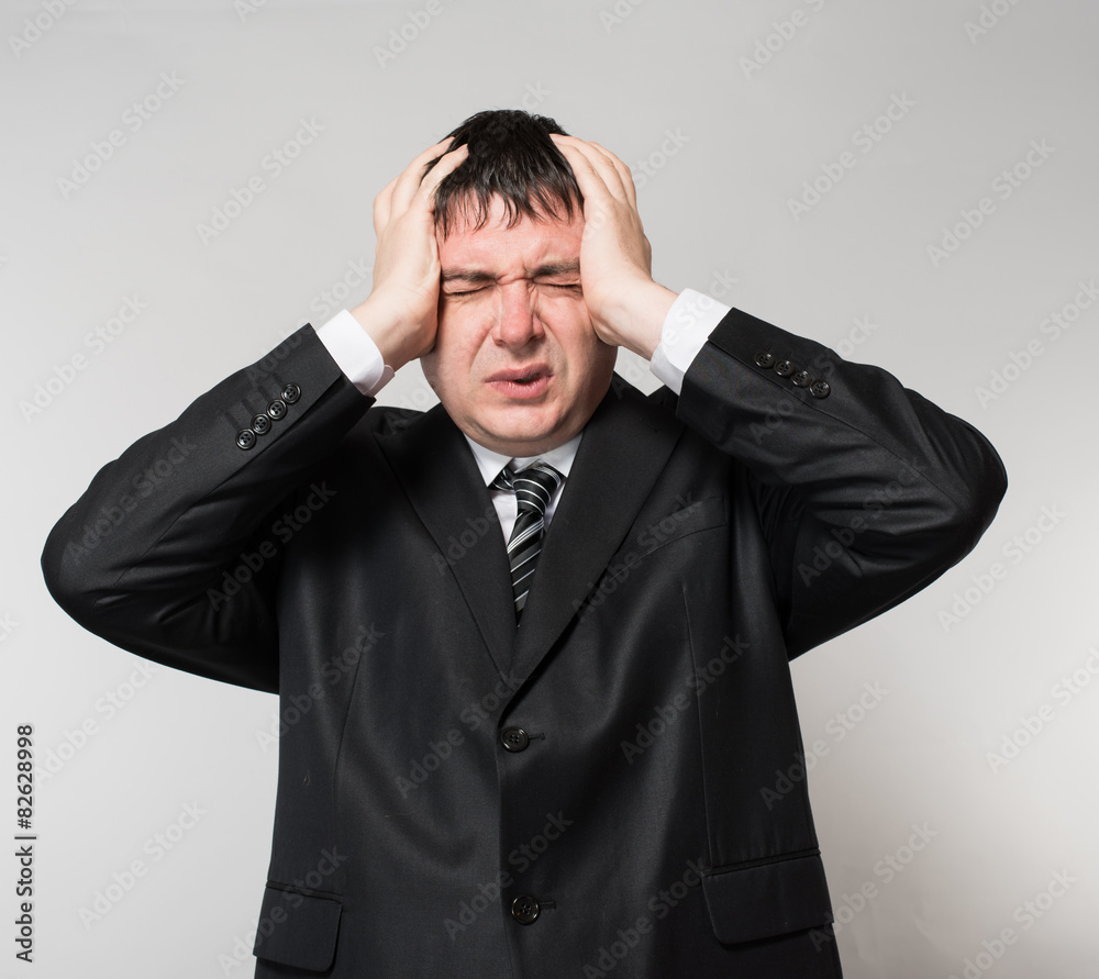 businessman in depression with hands on his head businessman in depression with hands on his head