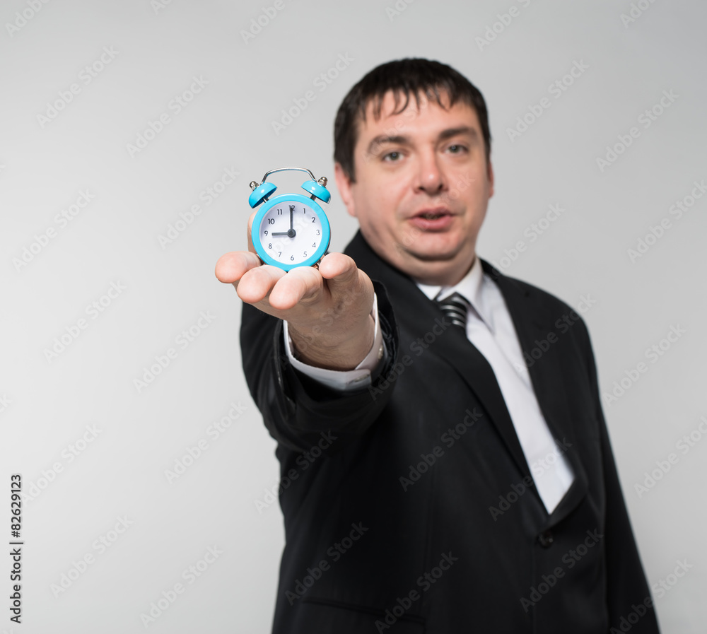 man holding an alarm clock in hands man holding an alarm clock in hands