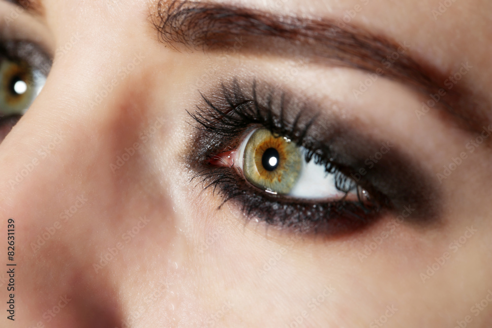 Fototapeta premium Eye of young woman with tear drop close up