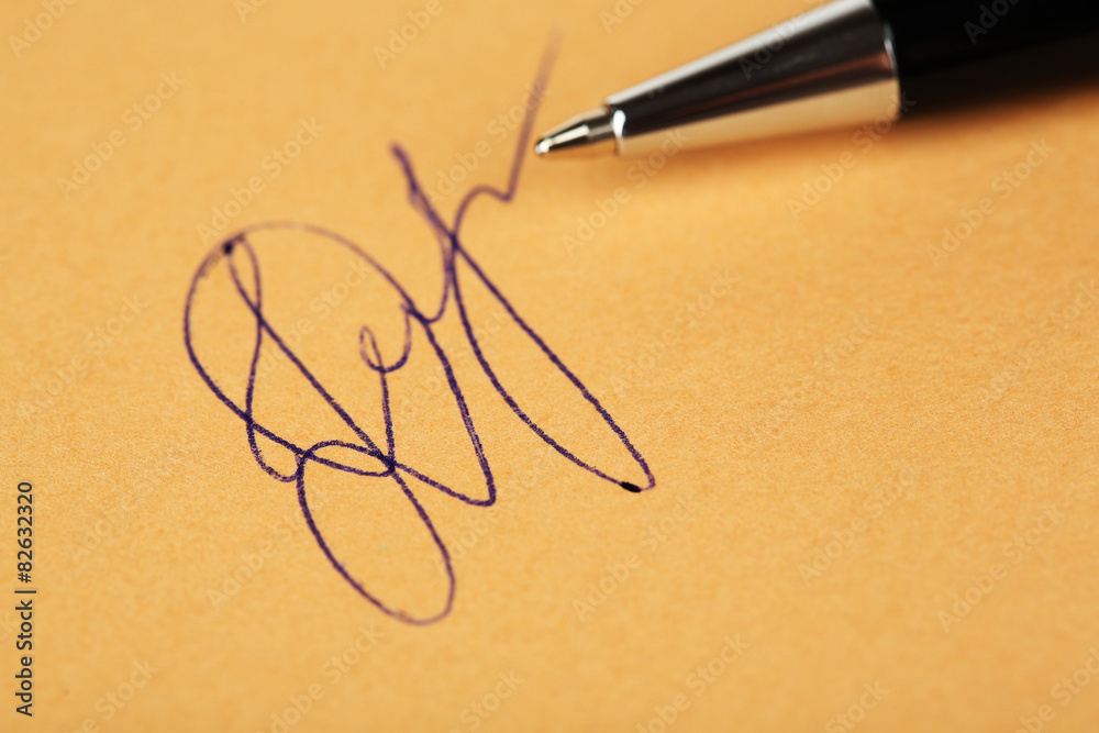 Fototapeta premium Pen and signature on paper background