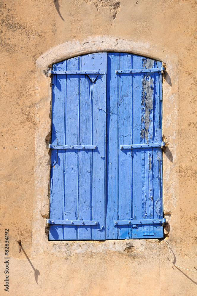 Closed shuttered window of French village house. Closed shuttered window of French village house.