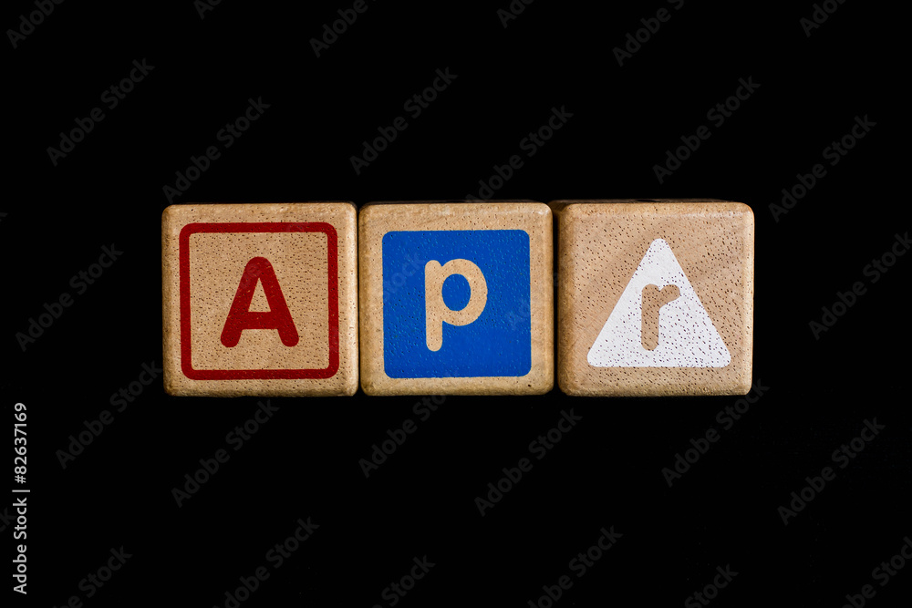 April on wood Cubic on black background