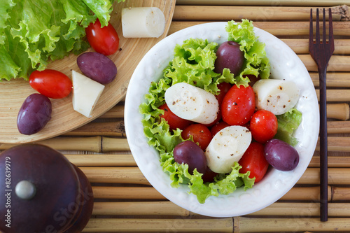 Fresh salad of heart of palm (palmito), cherry tomatos and olive