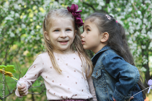 Girls sharing secrets among spring garden