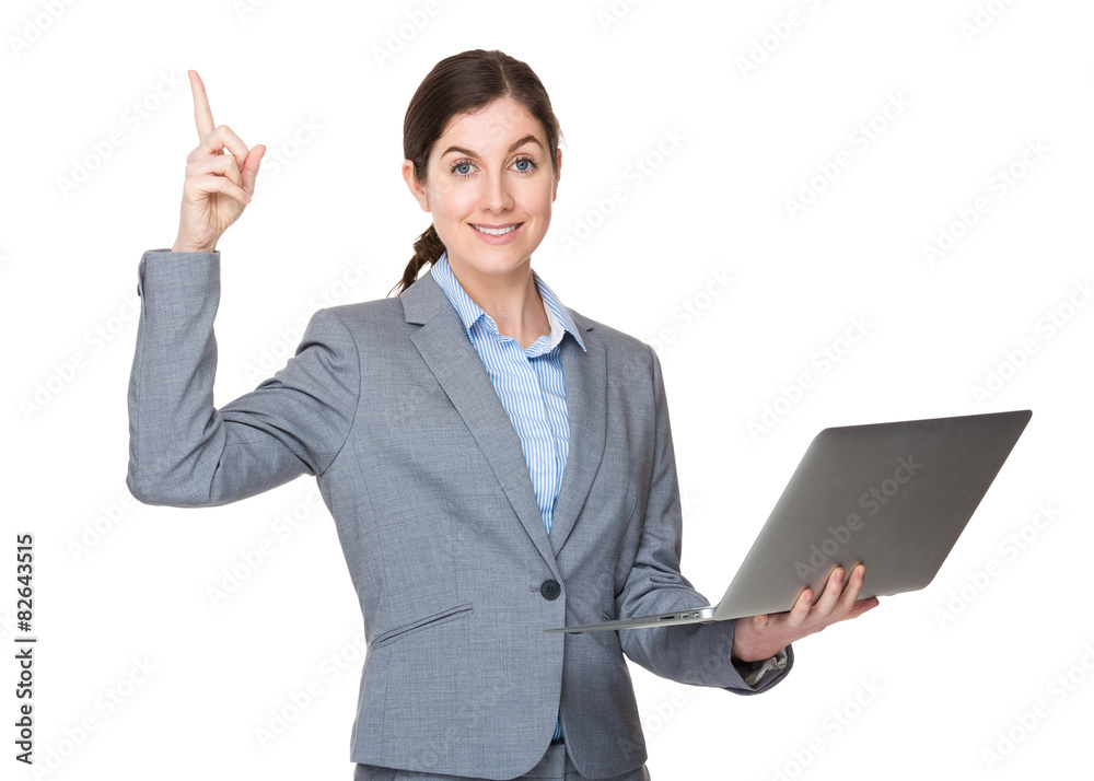 Businesswoman use of laptop and finger pointing up Businesswoman use of laptop and finger pointing up