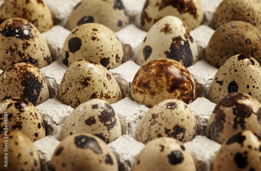 Quail eggs on a wooden table, selective focus