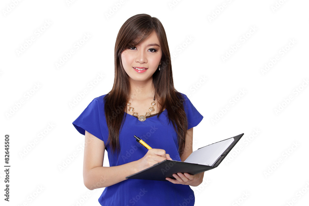 Young Asian woman holding pen and notebook, isolated on white Young Asian woman holding pen and notebook, isolated on white