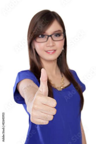 Young Asian woman giving thumb up, isolated on white