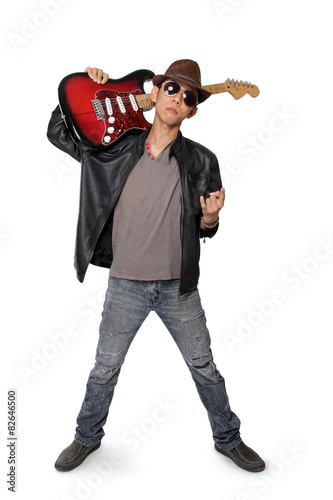 Young guitarist making metal hand sign, isolated on white