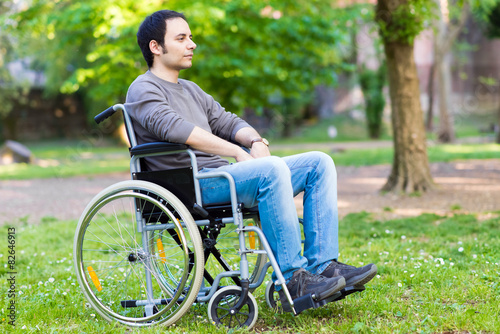 Man on a wheelchair relaxing in a park