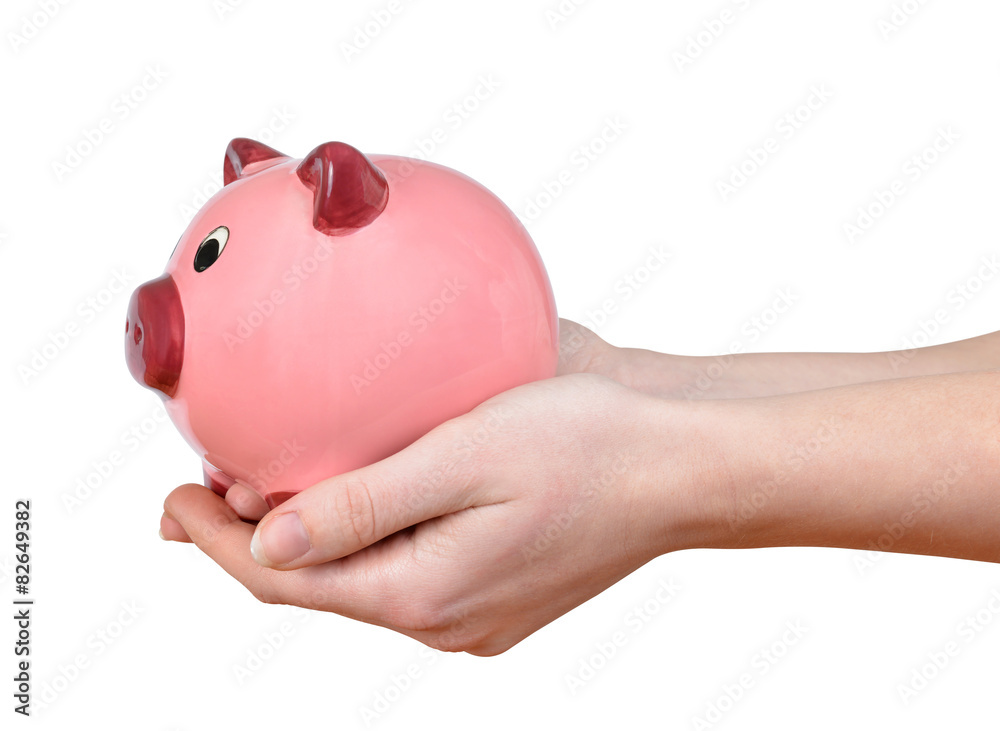 Woman hands holding a pink piggy bank isolated
